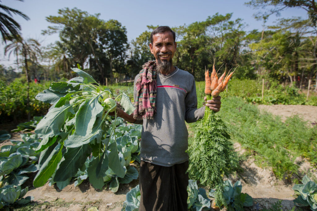 Farmer Abdul Aziz with his first harvest of salt-tolerant vegetables